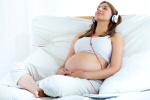 pregnant woman listening to headphones